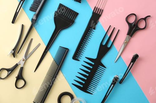 Preview: Flat lay composition with professional hairdresser tools on color background