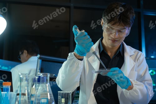 Preview: Team of biochemical research scientists working with a microscope for vaccine development