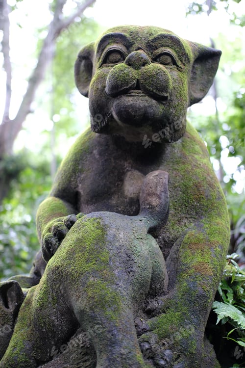 Preview: Close-up of a stone statue covered with moss in a garden