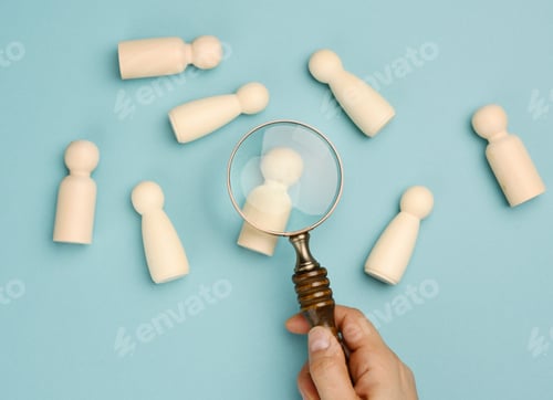 Preview: Wooden men and a magnifying glass on a blue background. Recruitment concept