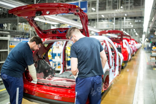 Preview: Two colleagues working in modern car factory