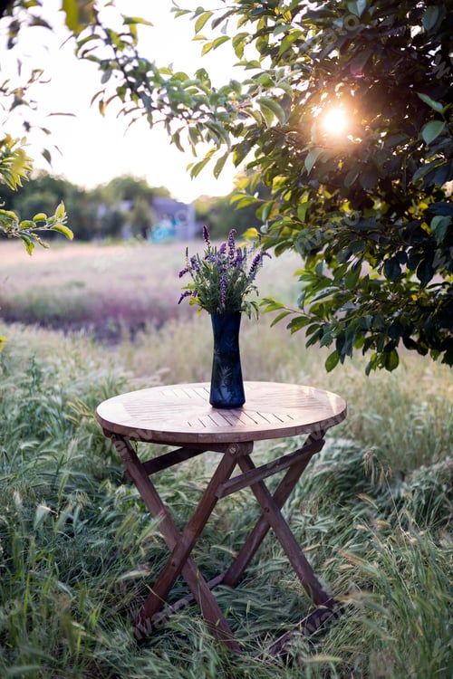 Preview: bouquet of sage on the table in the summer garden