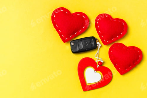 Preview: Top view of car key, wooden and textile hearts on colorful background. Saint Valentine