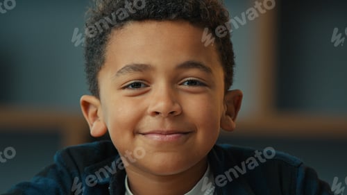 Preview: Close up portrait at home indoors little African American school boy ethnic son pupil schoolboy