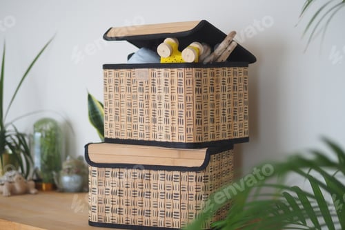 Preview: Decorative storage boxes on a wooden shelf with plants