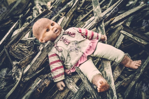 Preview: Abandoned old broken baby doll rots in scary forest.