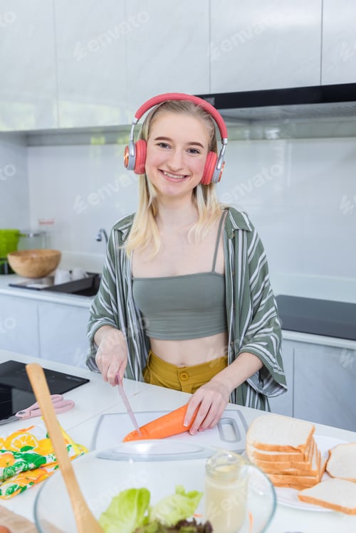 Preview: Girl at the kitchen Happy face. Preparing family dinner at home.