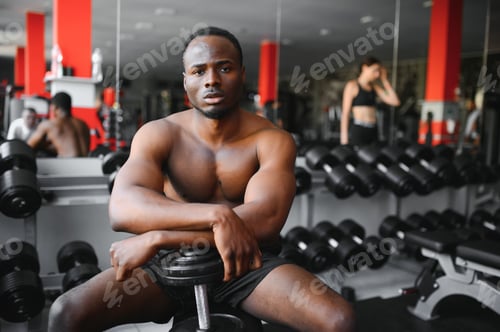 Preview: Tired african american man tired after working out in the gym.