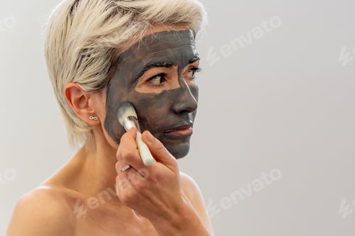 Preview: Woman Applying Facial Mask in her Home