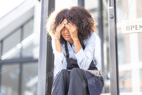 Preview: Portrait of Young african american small business owner woman wearing apron and looking away to you