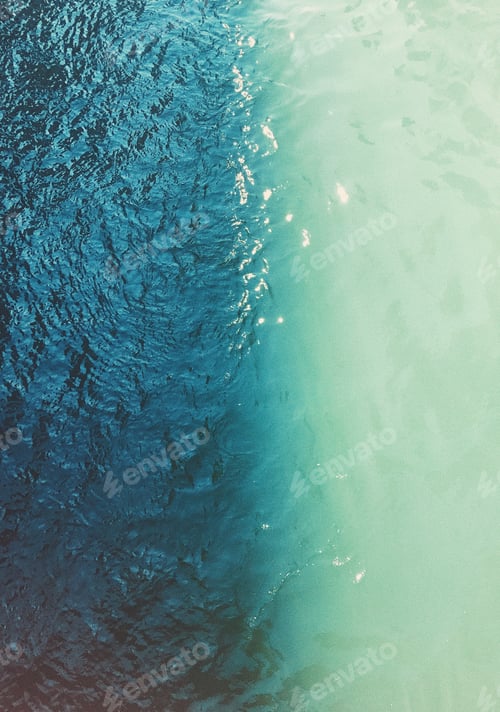 Preview: Aerial top view of waving shiny seawater in two different colors