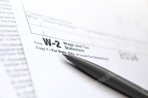 Preview: The pen lies on the tax form W-2 Wage and Tax Statement. The time to pay taxes