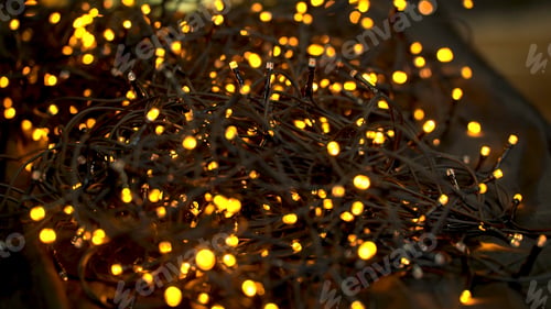 Preview: Beautiful garland with lights close up. selective focus of Christmas warm gold garland lights