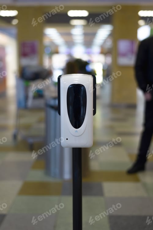 Preview: Spray antiseptic in a shopping mall indoors. Antibacterial sanitizer