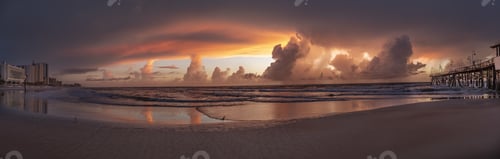 Preview: Panoramic shot of the beach and the fluffy clouds in the sky during sunset