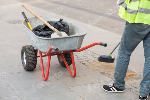 Preview: Road cleaning. The man is sweeping the sidewalk. City worker. Brick Road Cleaning by Pro