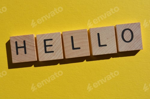 Preview: Hello in 3D wooden alphabet letters on a bright yellow background with copy space