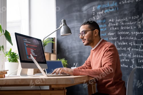 Preview: It-manager sitting in front of laptop in office and analyzing coded information