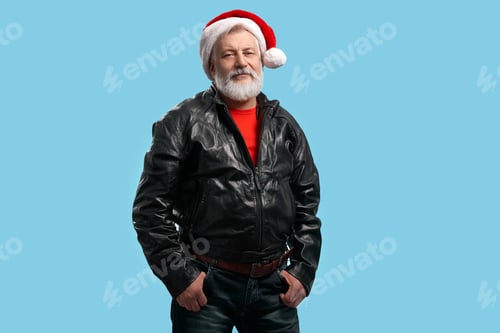 Preview: Confident senior man in Santa hat and black leather jacket