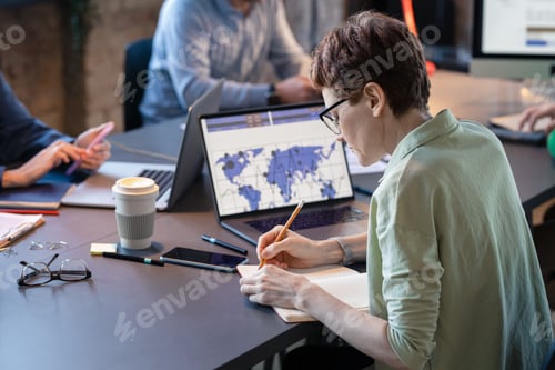 Preview: Businesswoman making notes during a meeting
