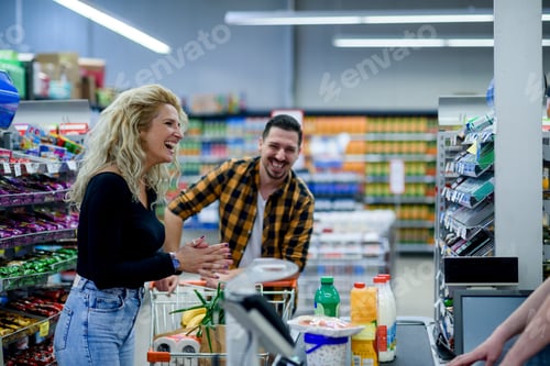 Preview: Beautiful couple buying groceries at the supermarket