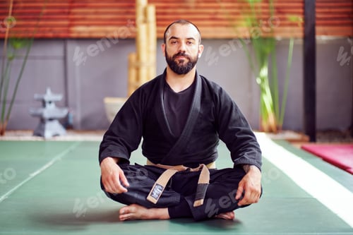 Preview: Martial arts master meditating sitting on tatami in lotus position