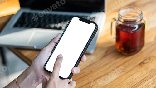Preview: female hands holding phone with isolated screen over table in cafe