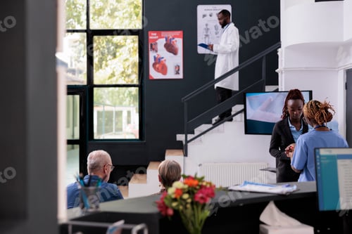 Preview: Medical assistant talking with receptionist discussing patients appointment