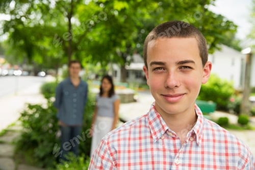 Preview: A boy on the farm, with two adults standing in the background.