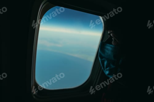 Preview: Virus. A Woman Flies In An Airplane Wearing A Medical Mask.