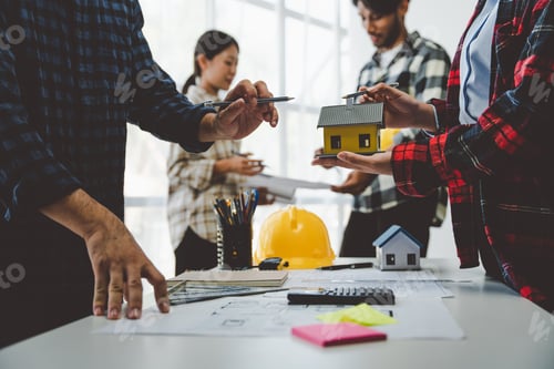 Preview: Engineers work as a team with blueprints for architectural plans. Engineer sketching construction pr