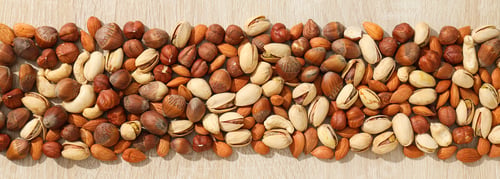 Preview: Assortment of different nuts on a wooden table