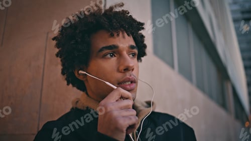 Preview: Man with Headphones in Urban Environment Looking Away