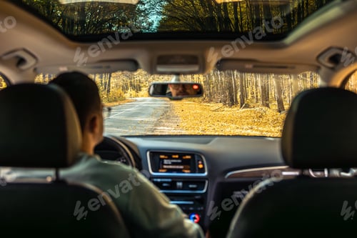 Preview: Driving the modern car on asphalt road. A young man drives a car.