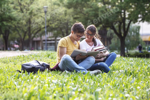 Preview: Two young students sitting at the campus yard