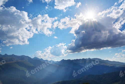 Preview: Mountain range and sunny sky with sun rays.