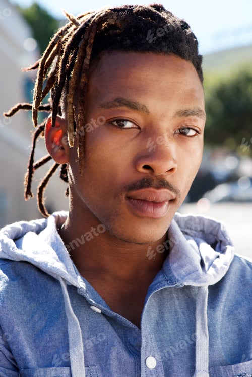 Preview: african man with dreadlocks staring outside