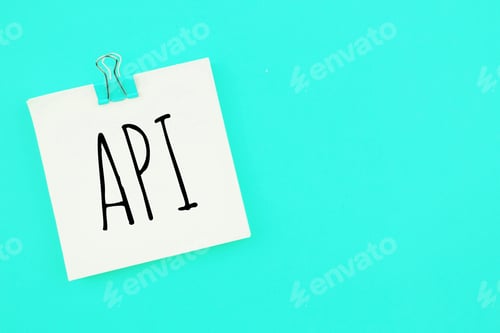 Preview: Note written on a white sticker with paper clip on a blue background . Inscription API