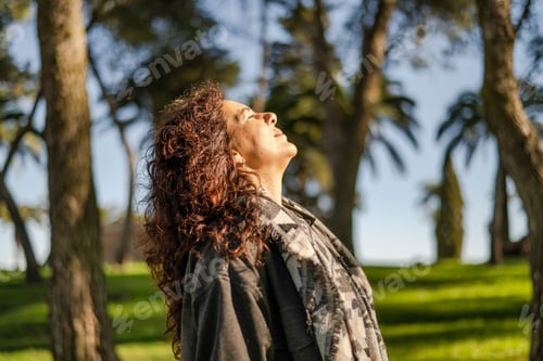 Preview: Woman enjoying fresh air breathing outdoors in park