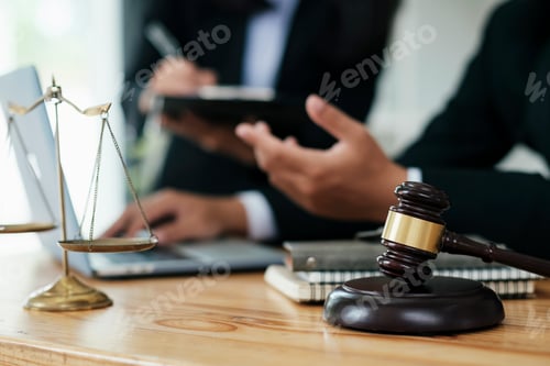Preview: Lawyer Signing Documents Near Mallet And Scales