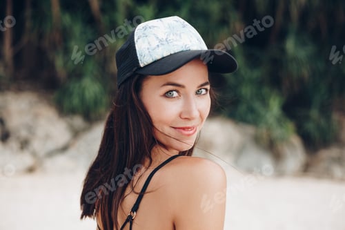 Preview: young smiling woman posing in cap