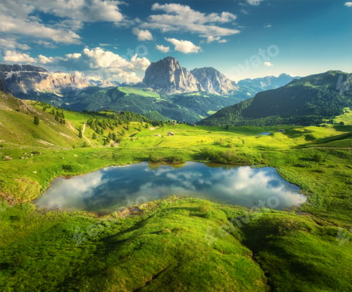 Preview: Aerial view of little alpine lake in mountains at sunset. Summer