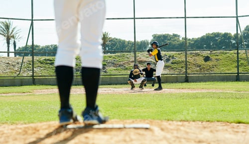 Preview: Cropped shot of a handsome young baseball player preparing to bat a ball during match on the field