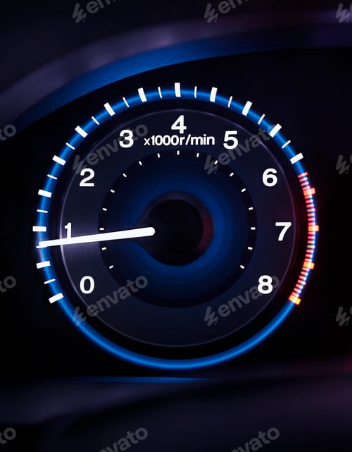 Preview: A lit up car dashboard guage, rev counter.