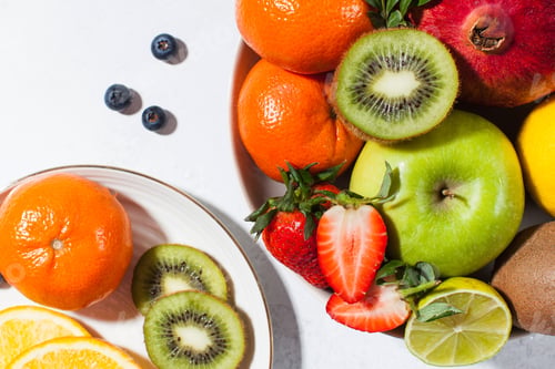 Preview: Flatlay assorted fresh and ripe fruits and berries on a plate. The concept of healthy eating.