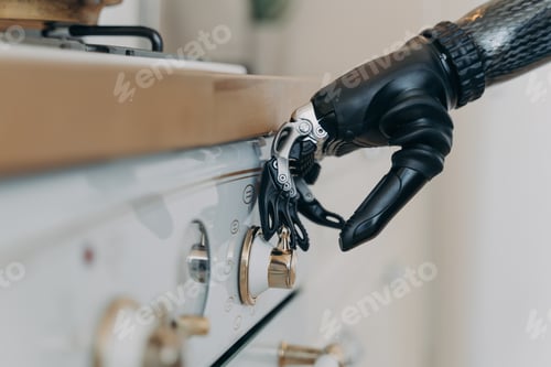 Preview: Carbon prosthetic hand of disabled is switching a stove on at kitchen. Routine of disabled person.