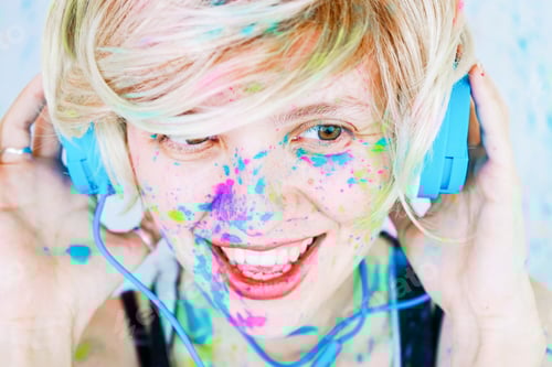 Preview: Young woman listening to music with paint in her face