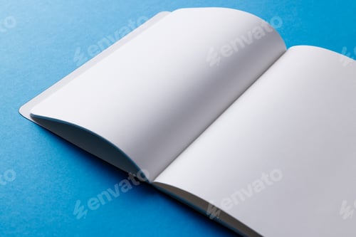 Preview: Close up of open book with copy space on blue background