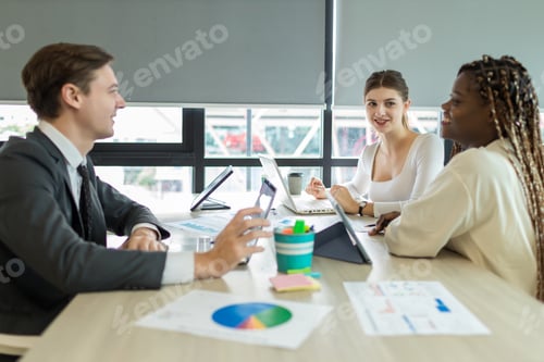 Preview: Diverse colleagues gather in brainstorm discuss statistics together.
