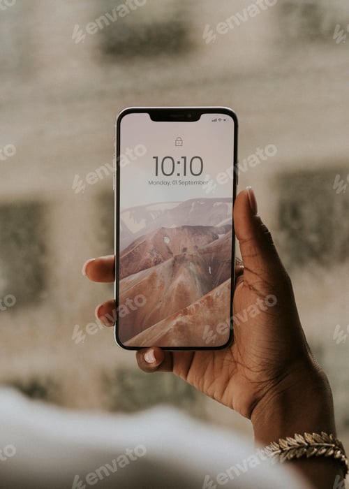 Preview: Hand holding smartphone by the window mockup